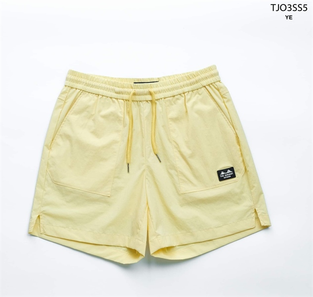 Pale yellow shorts laid flat from the front, loose drawcord, twin patch pockets and a small logo patch on the right pocket