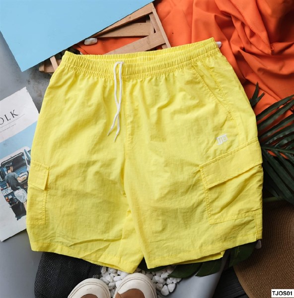 Yellow cargo shorts laid flat from the front, elastic waist with white drawstring and small embroidered logo